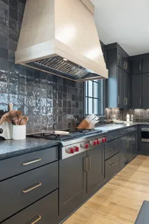 a spacious bedroom with a bed a couch and large window