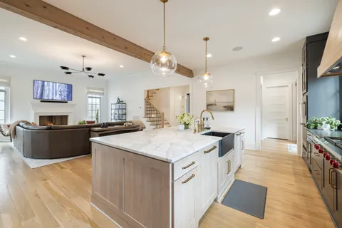 a spacious bathroom with a double vanity sink mirror and bathtub
