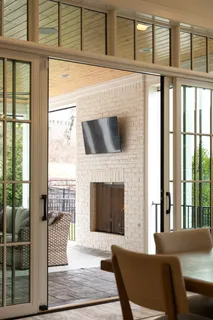 a living room with furniture a large window and a wooden floor