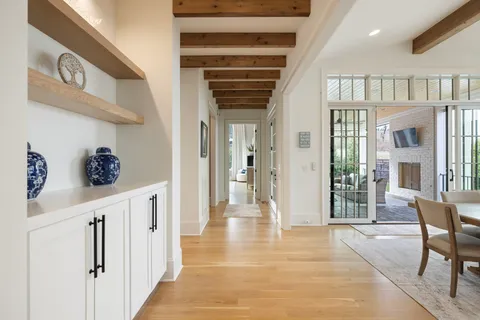 a spacious bedroom with a bed a couch and a large window