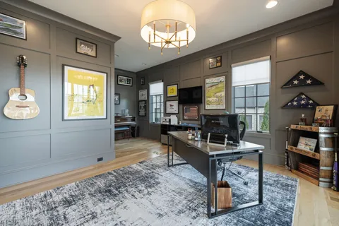 a living room with fireplace furniture and a large window