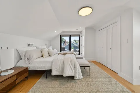 a spacious bedroom with a bed and a large window