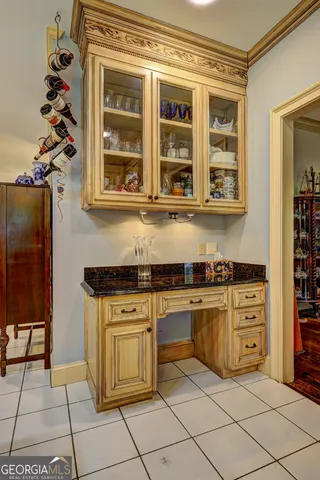 a bedroom with a bed a chandelier and flat screen tv