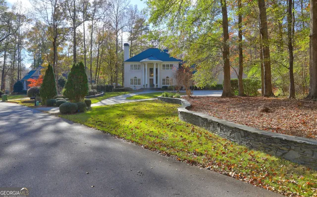 a view of a dining room with furniture a chandelier and a window