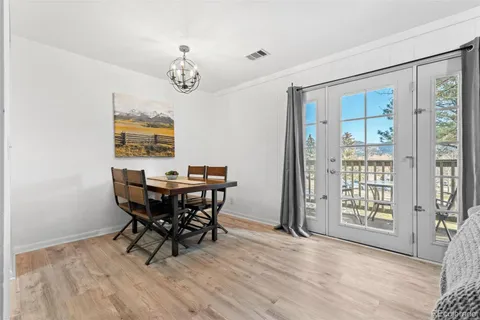 a view of a dining room with furniture and chandelier