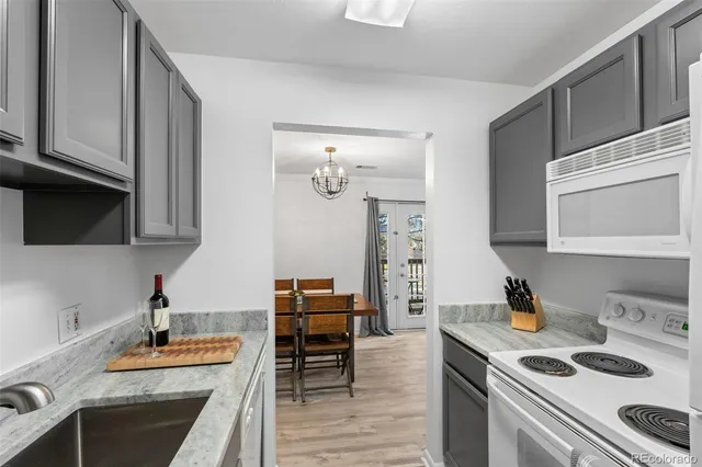 a kitchen with stainless steel appliances kitchen island granite countertop a sink stove and cabinets