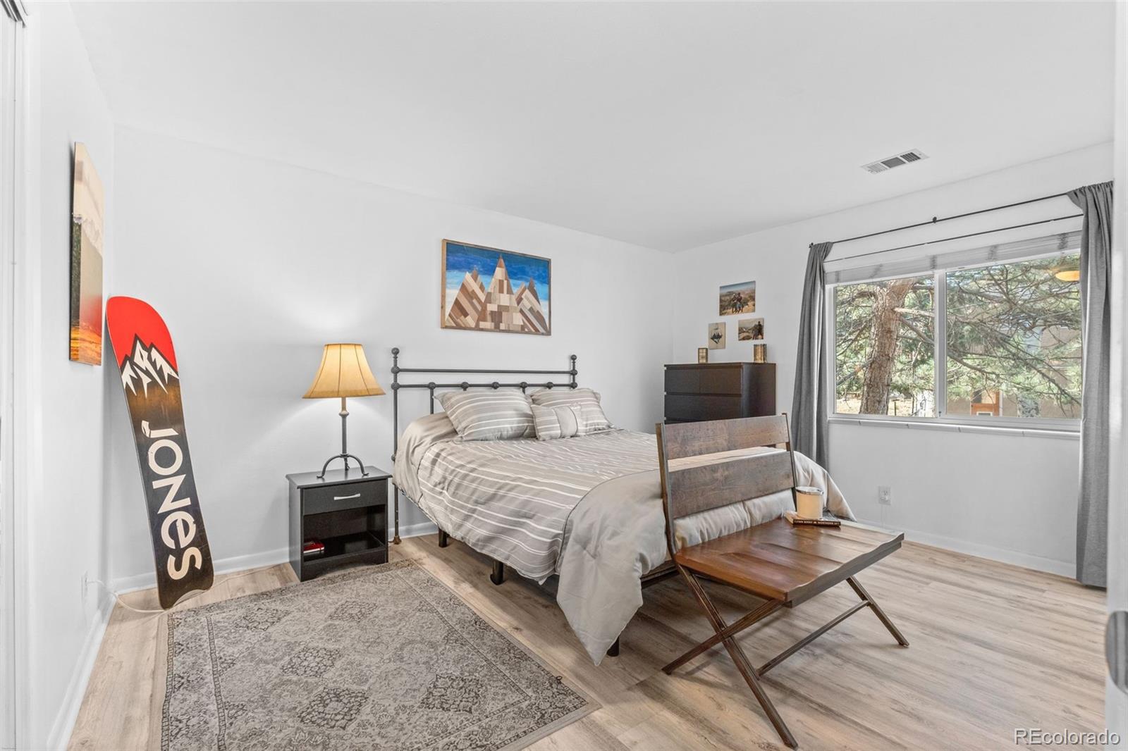 29656 Buffalo Park Road, Unit 206 Evergreen, CO 80439 - Photo 12 of 30 a bedroom with a bed and a flat screen tv