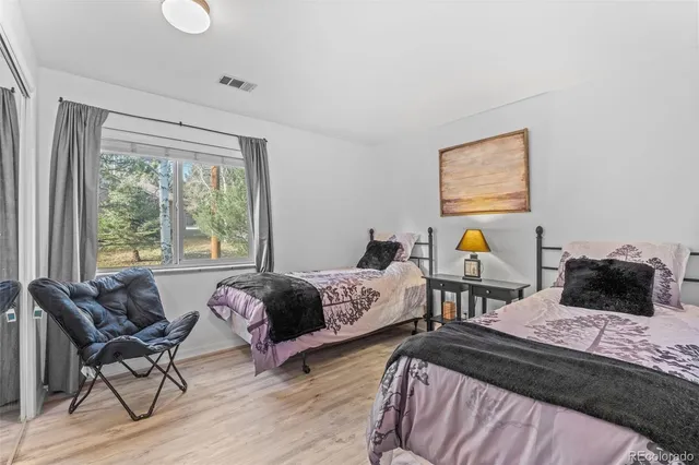 a bedroom with two beds and a window