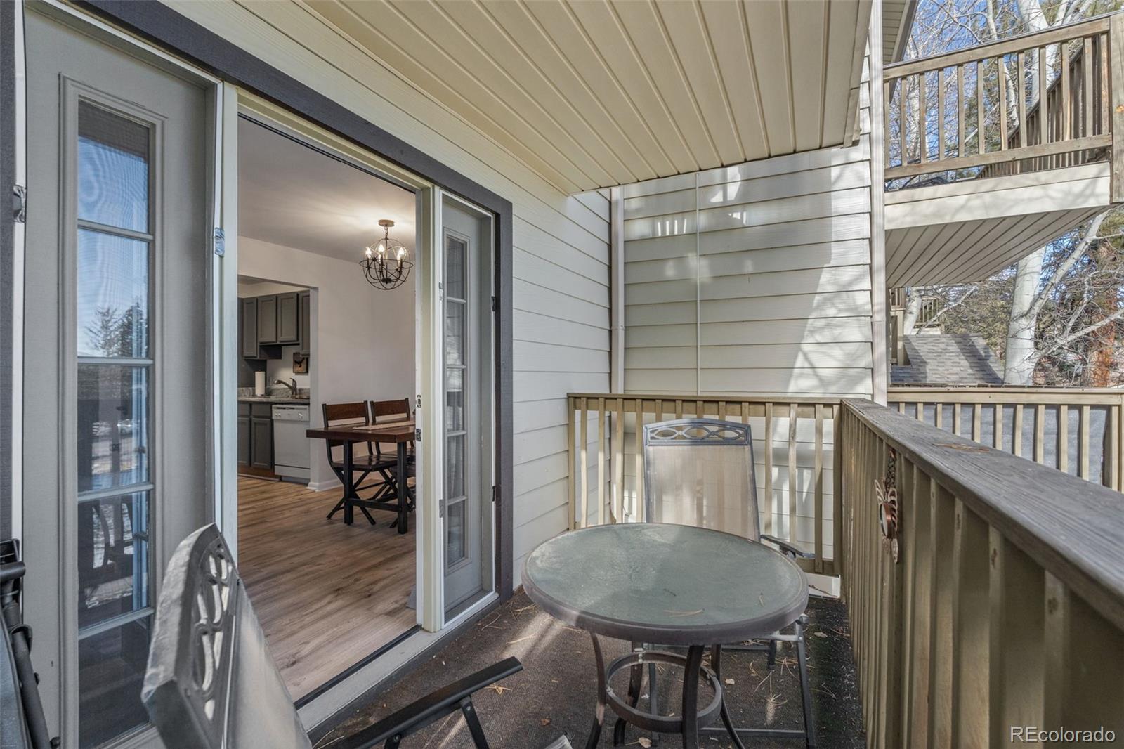 29656 Buffalo Park Road, Unit 206 Evergreen, CO 80439 - Photo 17 of 30 a view of a balcony dining table and chairs