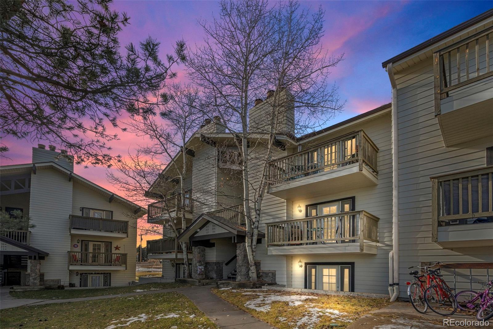 29656 Buffalo Park Road, Unit 206 Evergreen, CO 80439 - Photo 2 of 30 a view of a building with a large tree