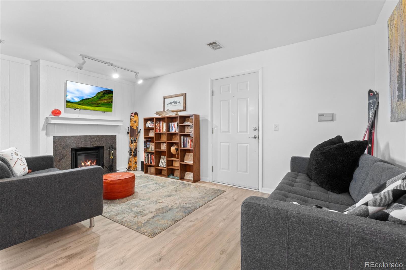 29656 Buffalo Park Road, Unit 206 Evergreen, CO 80439 - Photo 6 of 30 a living room with furniture a fireplace and a piano
