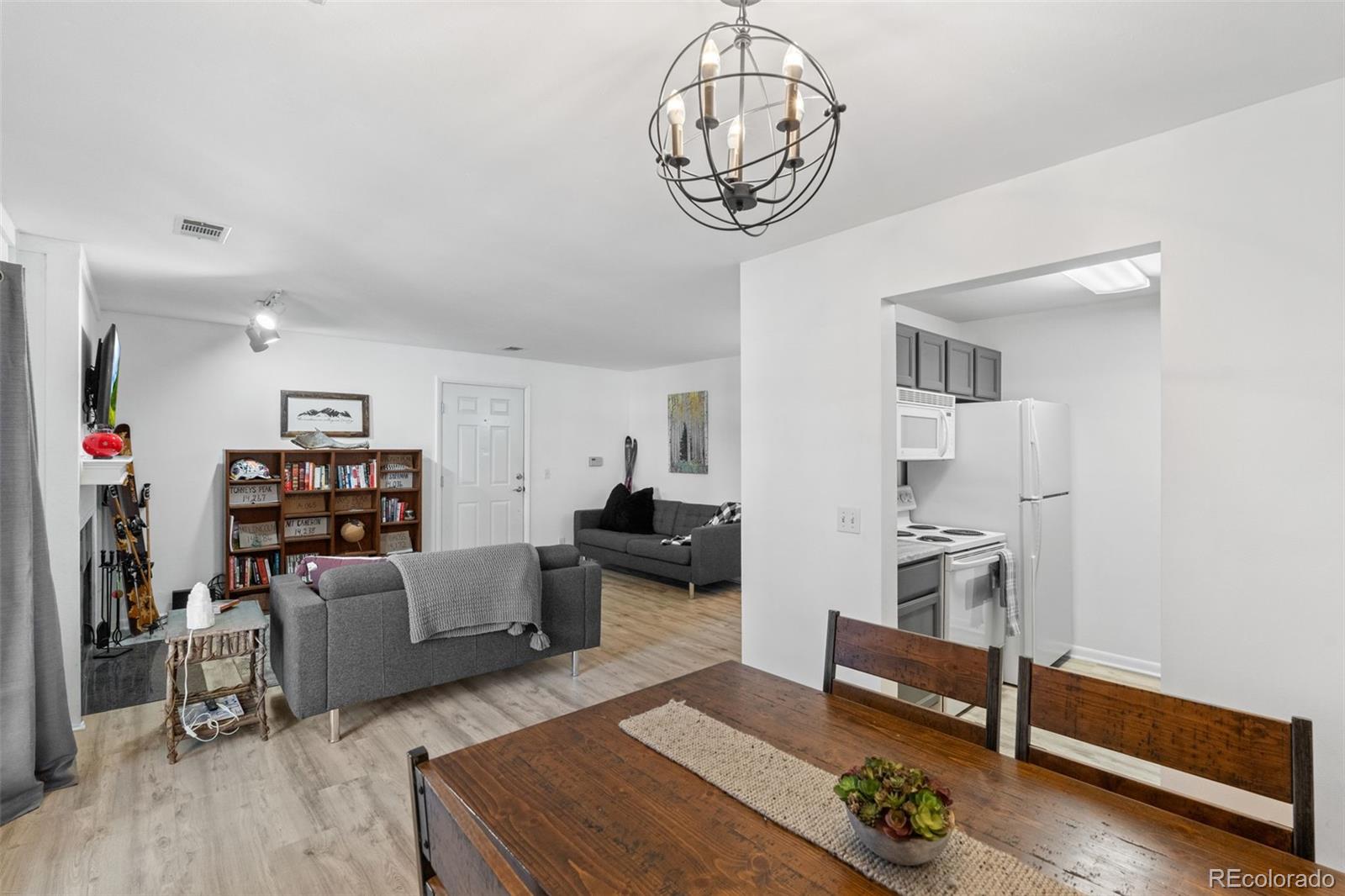 29656 Buffalo Park Road, Unit 206 Evergreen, CO 80439 - Photo 8 of 30 a living room with furniture and a wooden floor