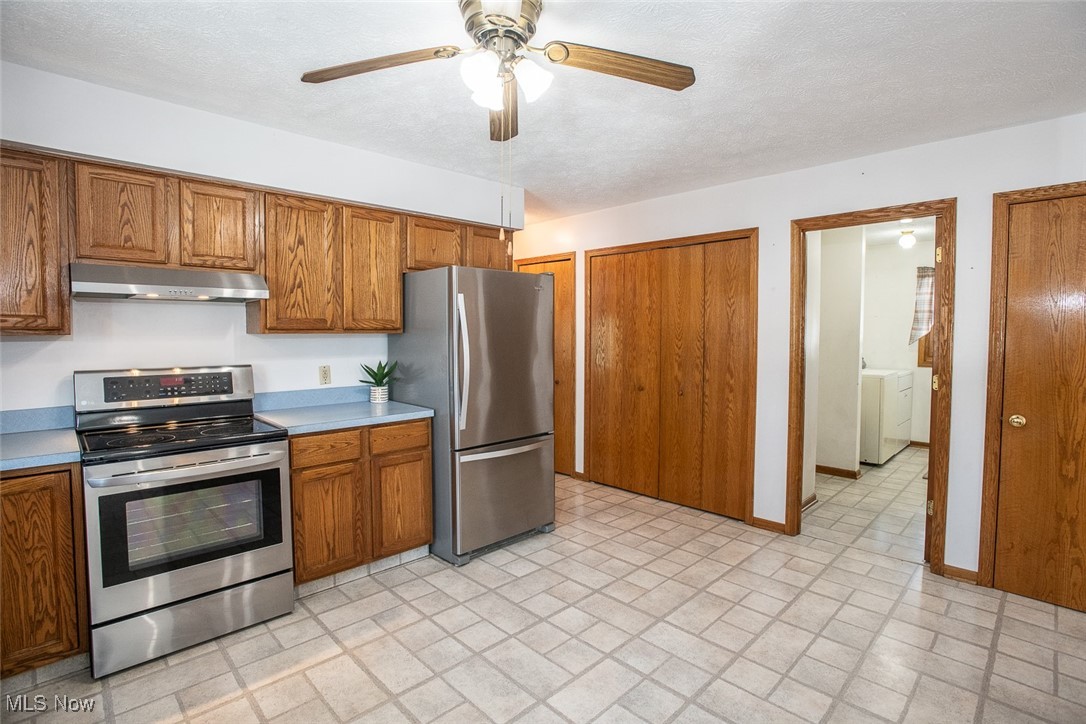 2624 Lester Road Medina, OH 44256 - Photo 14 of 50 Eat in Kitchen with Stainless Steel appliances range hood and vinyl flooring and 2 pantries