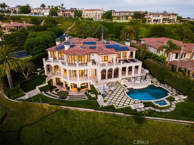 an aerial view of multiple houses with yard