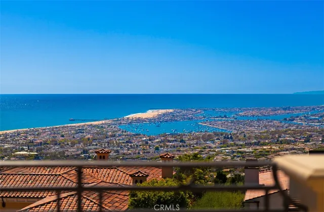 a view of swimming pool with outdoor seating and trees in the background