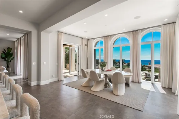 a view of a dining room with furniture large windows and wooden floor