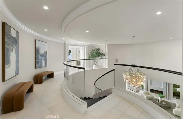 a living room with furniture flat screen tv and white walls