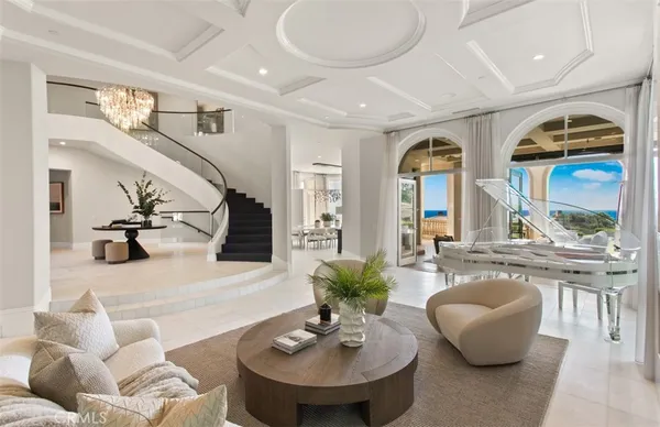 a living room with patio furniture and a potted plant