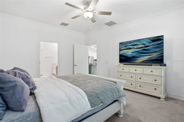 a bedroom with a bed and flat screen tv