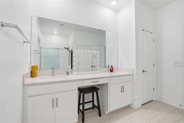 a view with two sink a mirror and a window