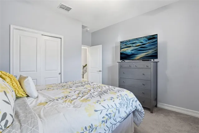 a bedroom with a bed and a dresser