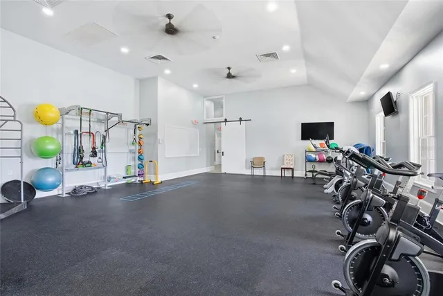 a view of a dining room with furniture a chandelier and wooden floor