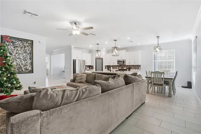 a living room with furniture and a chandelier