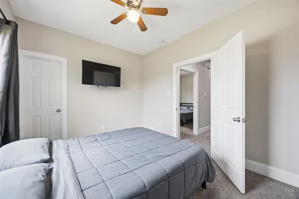 a bedroom with a bed and a flat screen tv