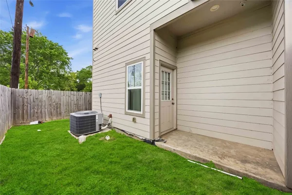 a view of a backyard with wooden fence