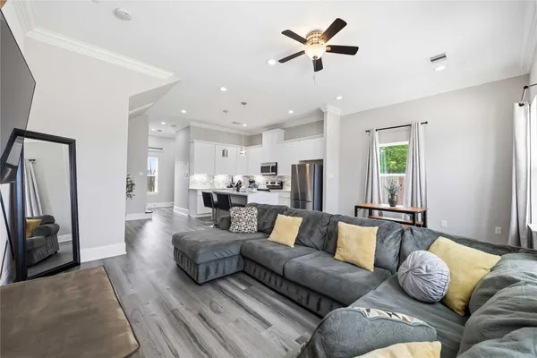a living room with furniture ceiling fan and a rug