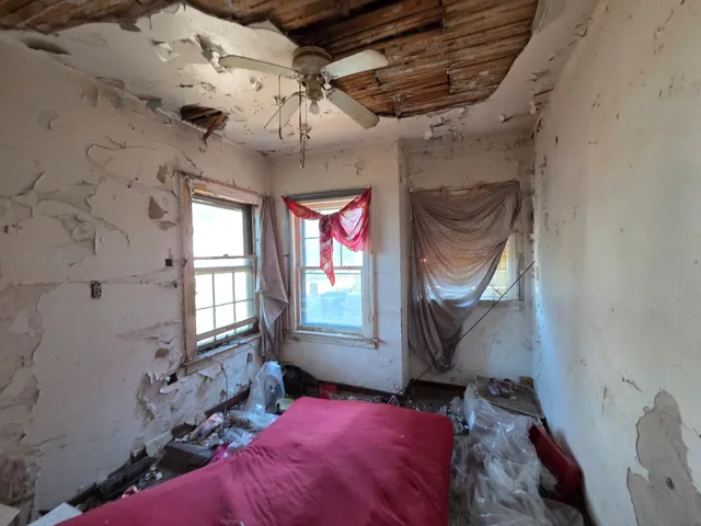 a bed room with a bed and a television