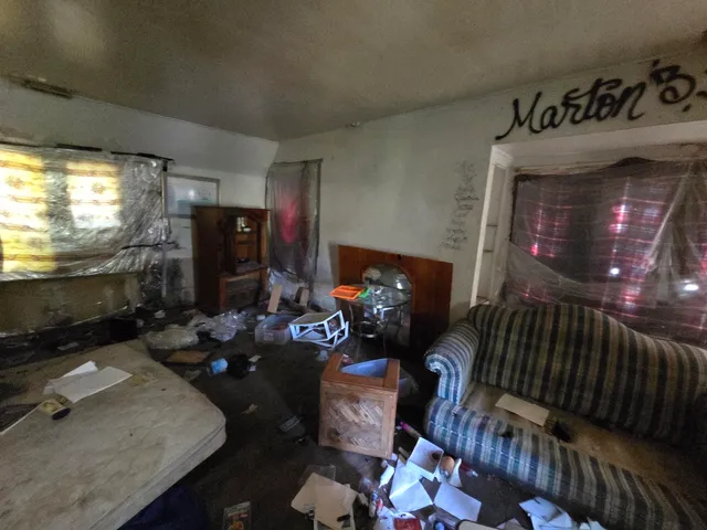 a bedroom with furniture and a flat screen tv