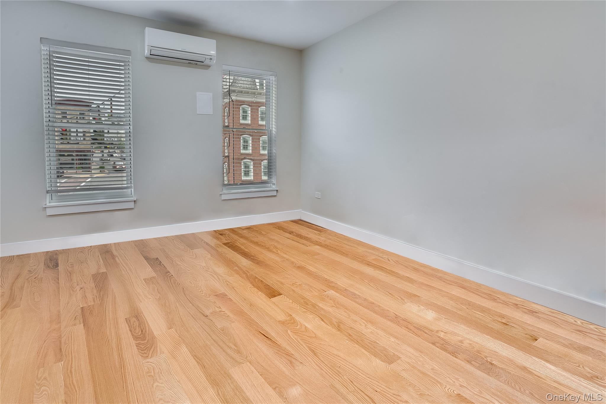 16 South Division Street, Unit 2B Peekskill, NY 10566 - Photo 4 of 8 a view of empty room with wooden floor and fan