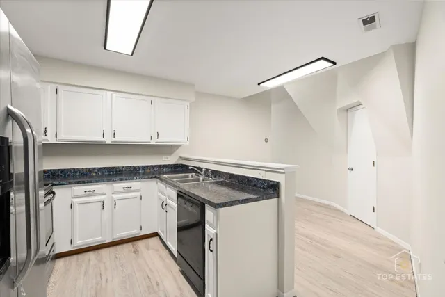 a kitchen with a stove a sink and a refrigerator