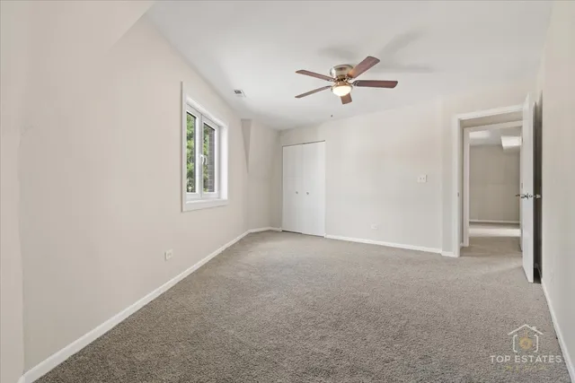 a view of a livingroom with a ceiling fan and window