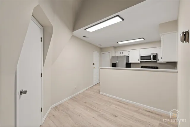 a view of a kitchen from a hallway
