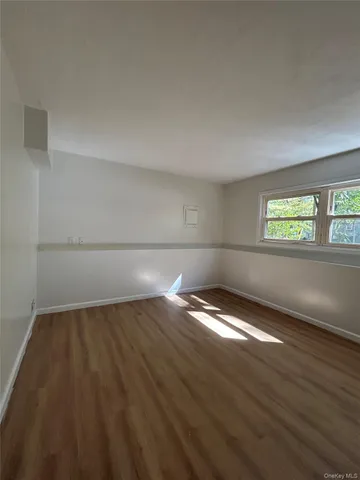 a view of wooden floor and windows in a room