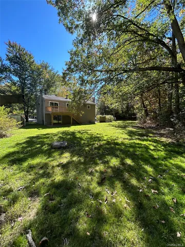 a backyard of a house with large trees