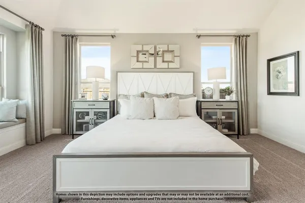a bed sitting in a bedroom next to a window