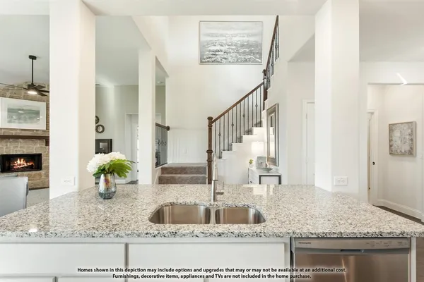 a kitchen with kitchen island granite countertop a sink and a counter top space