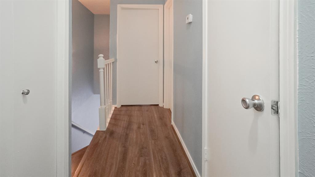 12921 Abrams Road, Unit 505 Dallas, TX 75243 - Photo 13 of 24 a view of a hallway with wooden floor