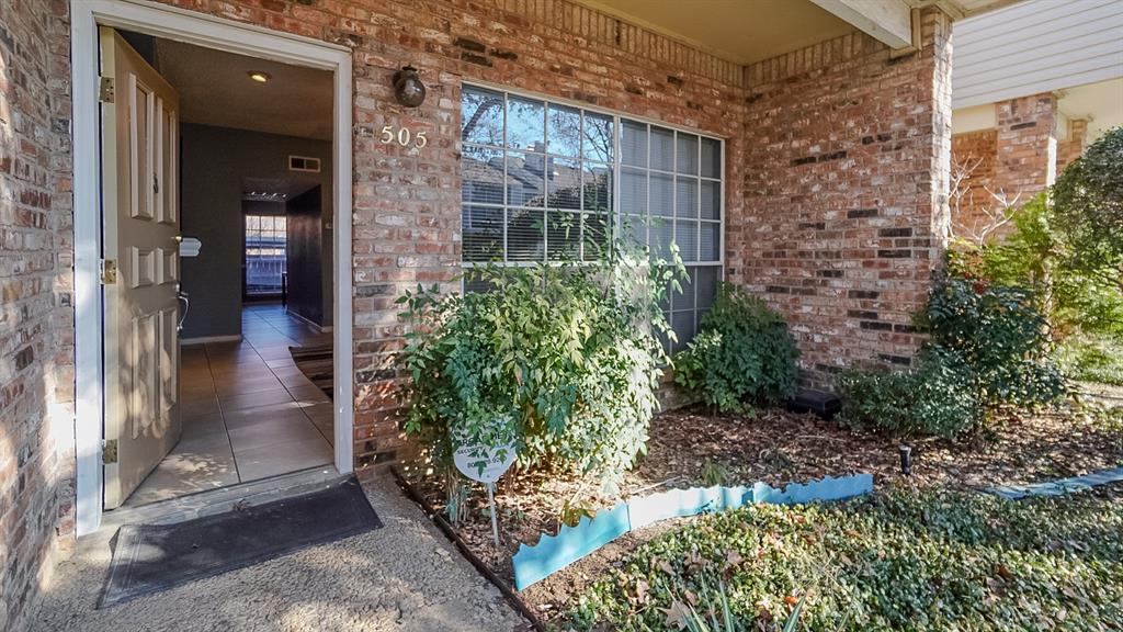 12921 Abrams Road, Unit 505 Dallas, TX 75243 - Photo 2 of 24 a view of a brick house with a yard
