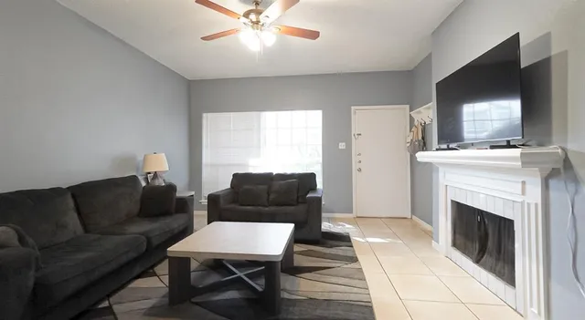a living room with furniture and a fireplace
