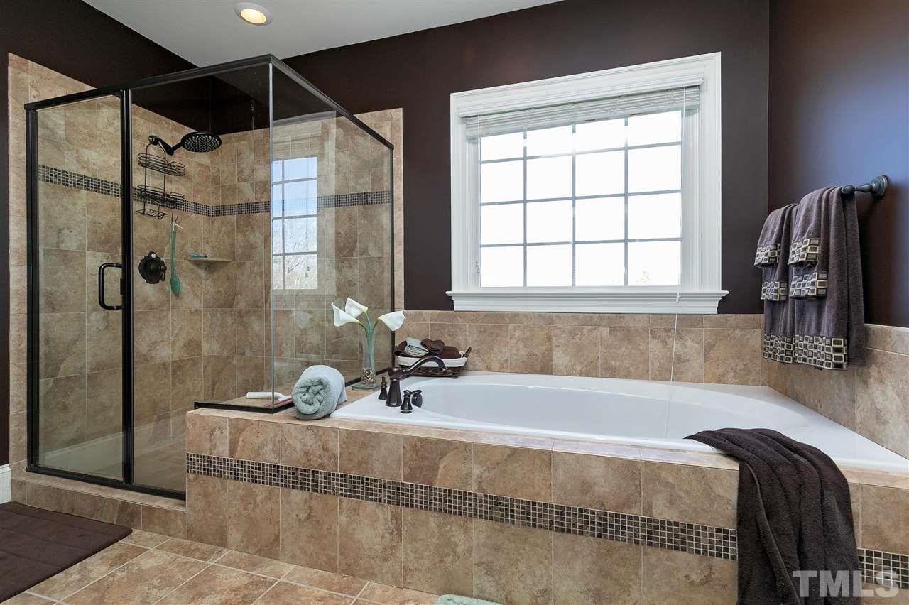 2829 Winter Song Road Raleigh, NC 27614 - Photo 20 of 30 SPA RETREAT WITH DOUBLE GRANITE VANITIES AND TILE UPGRADES. LOOKS NEW!! HUGE CLOSET WITH BUILT IN WOOD SHELVING.