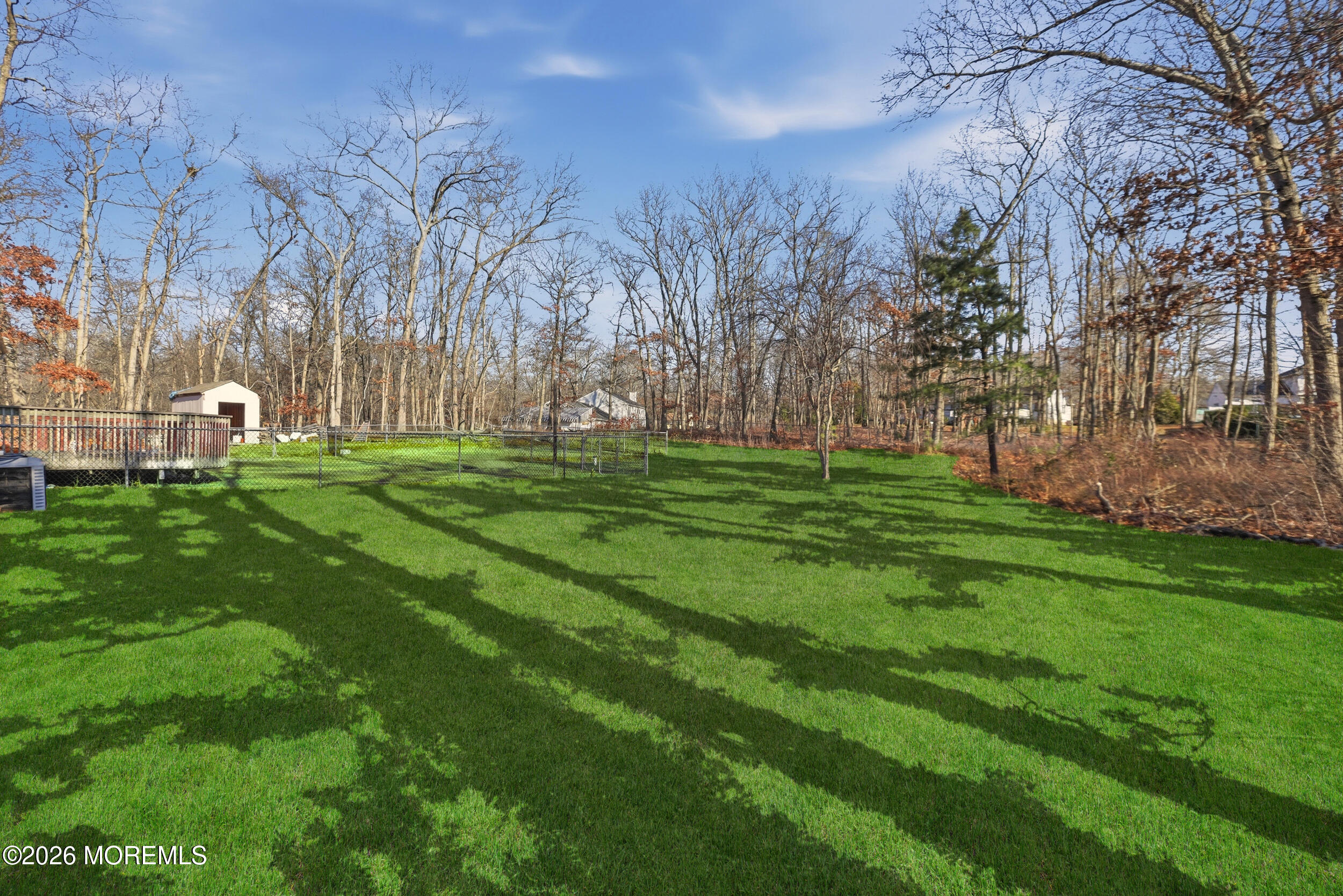 153 South Hope Chapel Road Jackson, NJ 08527 - Photo 6 of 10 a backyard of a house with lots of green space and trees