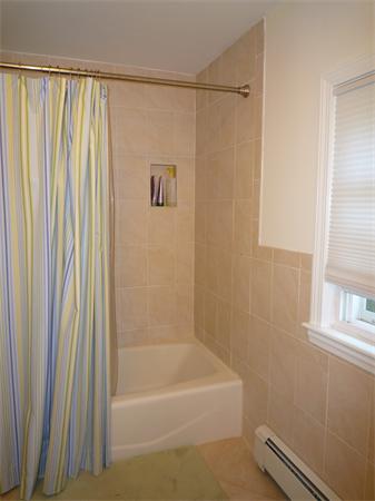 9 Bridge Street Lexington, MA 02421 - Photo 14 of 20 a bathroom with a shower curtain and a window