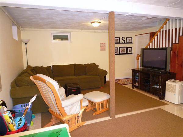 9 Bridge Street Lexington, MA 02421 - Photo 15 of 20 a living room with furniture and a flat screen tv