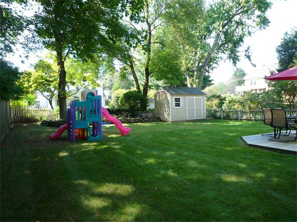 9 Bridge Street Lexington, MA 02421 - Photo 20 of 20 a view of a house with backyard and a tree