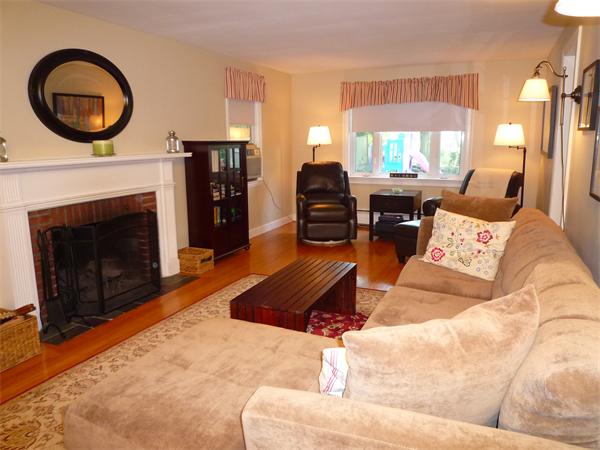 9 Bridge Street Lexington, MA 02421 - Photo 3 of 20 a living room with furniture a fireplace and a large window
