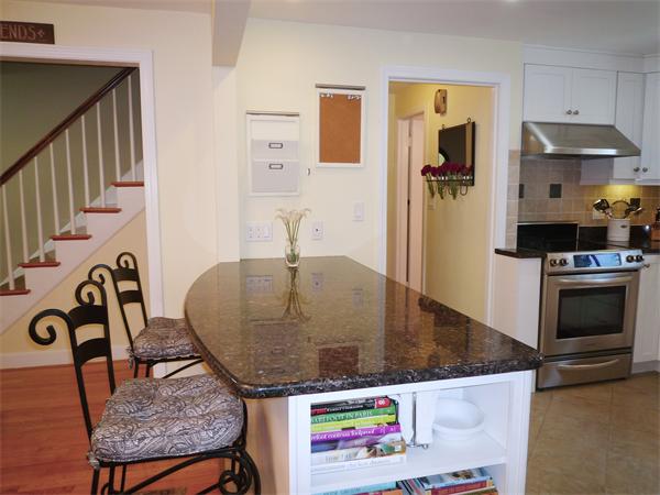 9 Bridge Street Lexington, MA 02421 - Photo 7 of 20 a kitchen with granite countertop a stove and a refrigerator